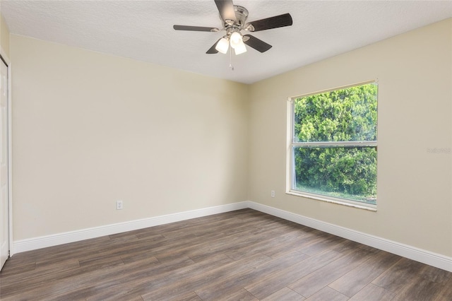 spare room with hardwood / wood-style flooring, a textured ceiling, and ceiling fan