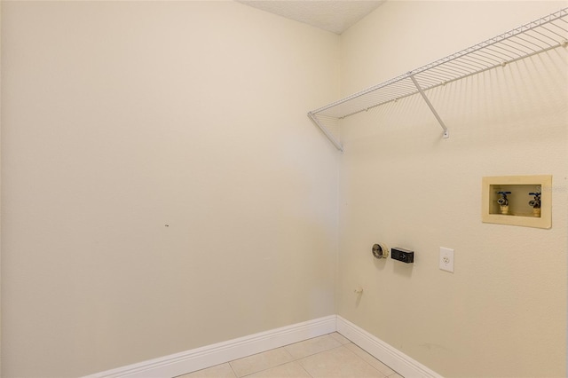 washroom with washer hookup, electric dryer hookup, and light tile patterned floors