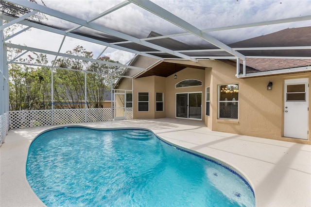 view of swimming pool with glass enclosure and a patio area