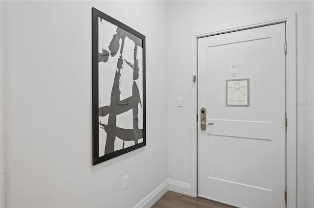 foyer with wood finished floors and baseboards