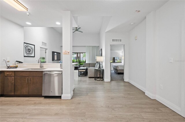 kitchen featuring ceiling fan, high vaulted ceiling, light hardwood / wood-style floors, dishwasher, and sink