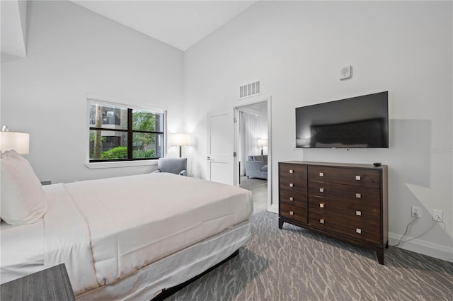 bedroom featuring visible vents, high vaulted ceiling, carpet, and baseboards