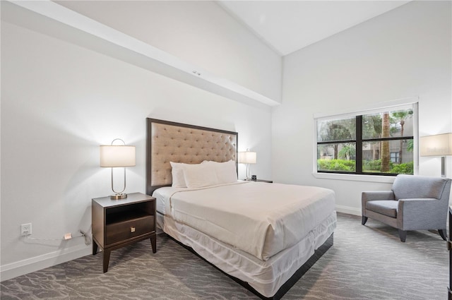 bedroom with high vaulted ceiling, baseboards, and carpet floors