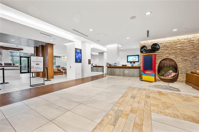 exercise area with light wood finished floors, visible vents, and recessed lighting