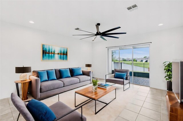 living room with ceiling fan and light tile patterned flooring