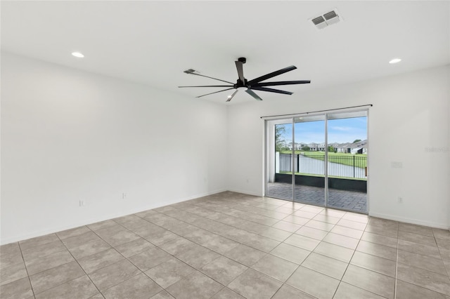 empty room with light tile patterned floors and ceiling fan