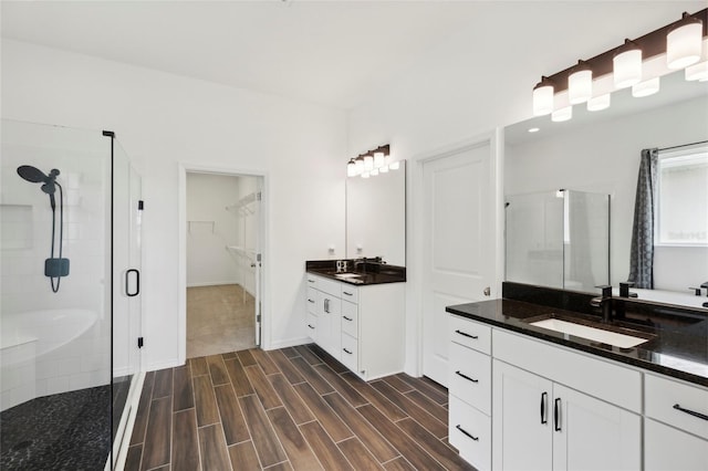 bathroom with vanity and a shower with shower door