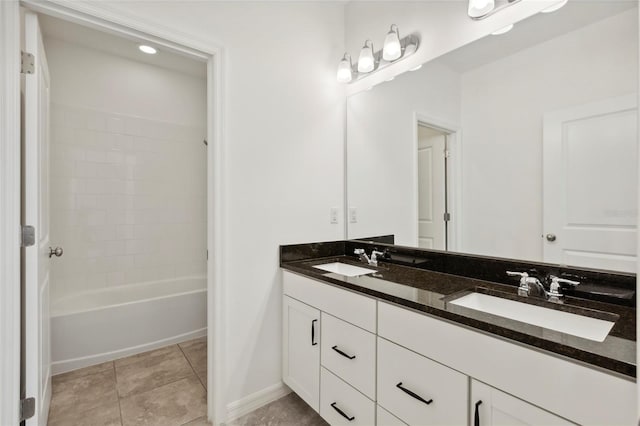 bathroom with washtub / shower combination, vanity, and tile patterned floors