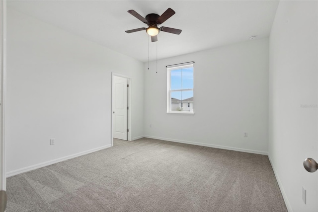 unfurnished room with ceiling fan and carpet flooring