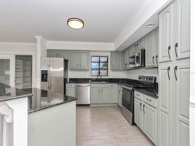 kitchen featuring ornamental molding, gray cabinetry, sink, light tile patterned flooring, and stainless steel appliances