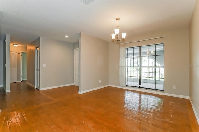 unfurnished room featuring recessed lighting, wood-type flooring, baseboards, and an inviting chandelier