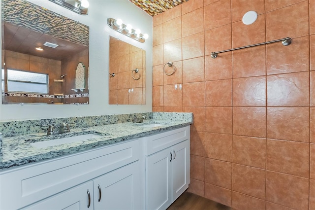 bathroom featuring tile walls and vanity