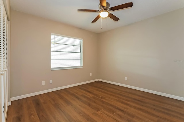 spare room with ceiling fan and dark wood-type flooring