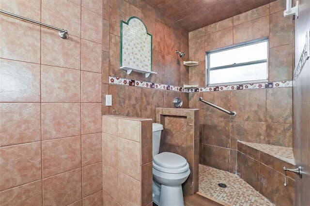 bathroom featuring toilet and a tile shower