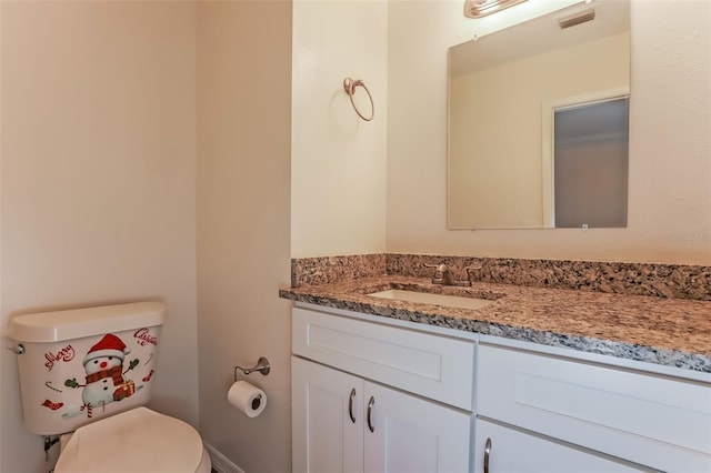 bathroom featuring toilet and vanity