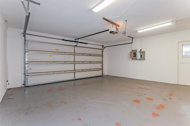 garage with a garage door opener and electric panel