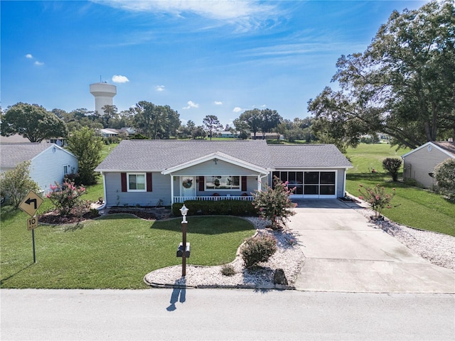 ranch-style home featuring covered porch, a front yard, and a carport