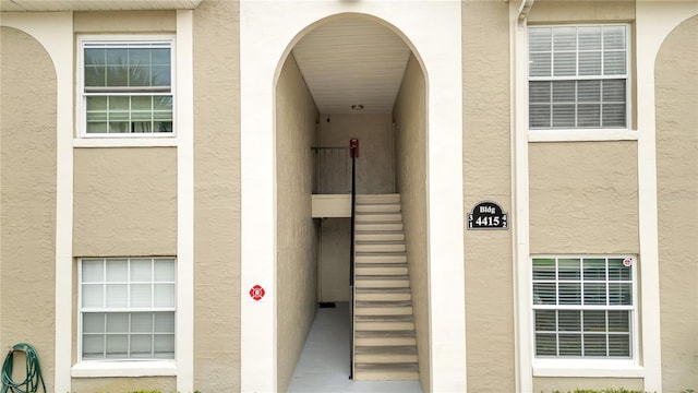 doorway to property with stucco siding