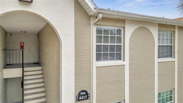 property entrance with stucco siding