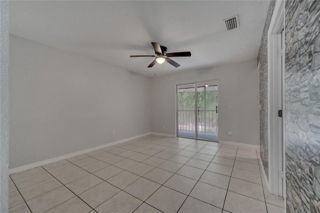 empty room featuring ceiling fan and light tile patterned flooring