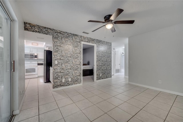 unfurnished living room featuring ceiling fan and light tile patterned flooring