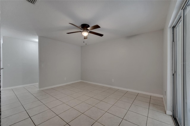 tiled spare room with ceiling fan