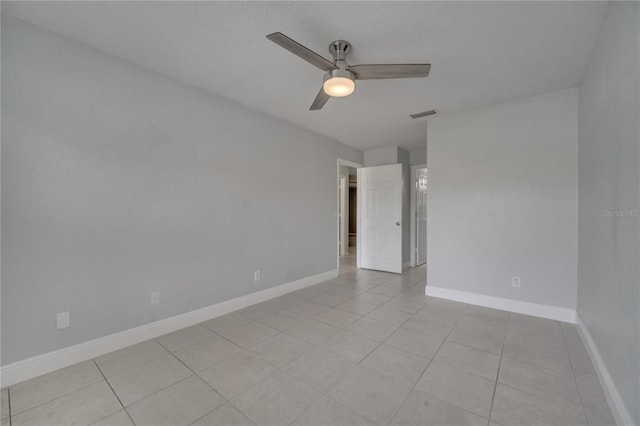 empty room featuring ceiling fan and light tile patterned floors