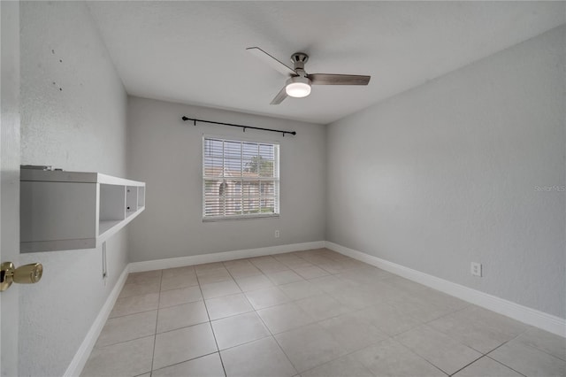 unfurnished room with ceiling fan and light tile patterned floors