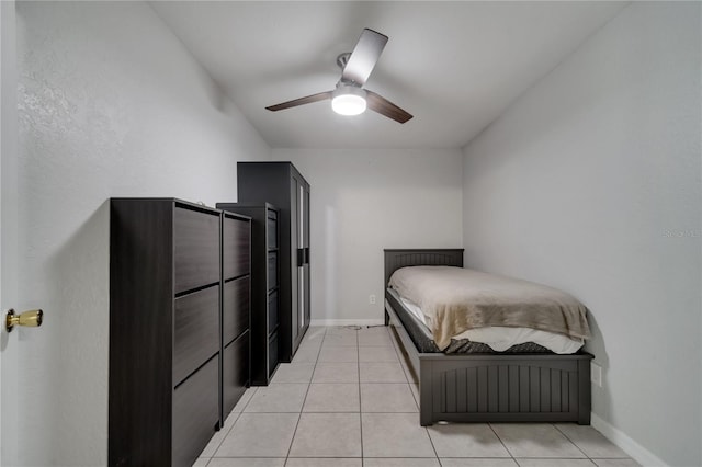 bedroom with ceiling fan and light tile patterned floors