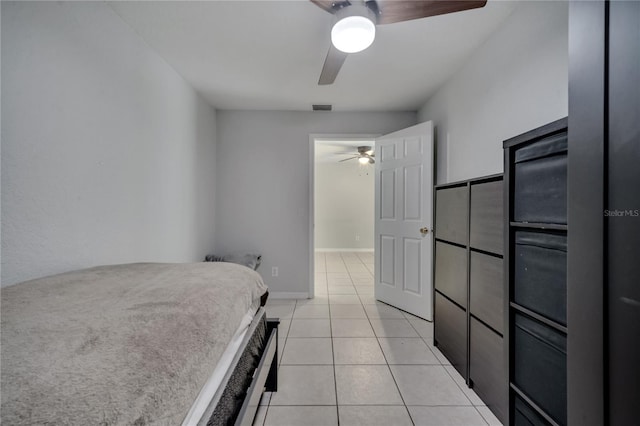 unfurnished bedroom featuring ceiling fan and light tile patterned floors