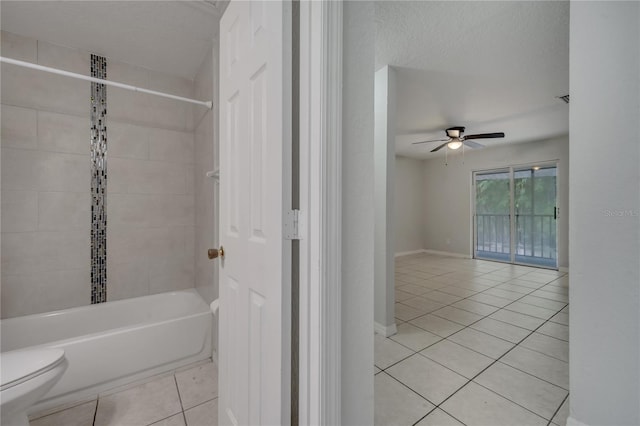 bathroom with tile patterned flooring, ceiling fan, toilet, and tiled shower / bath