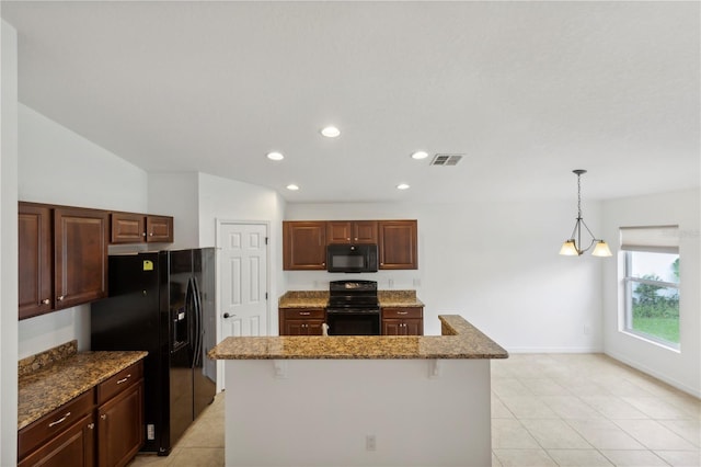 kitchen featuring black appliances, stone countertops, decorative light fixtures, a chandelier, and a kitchen island