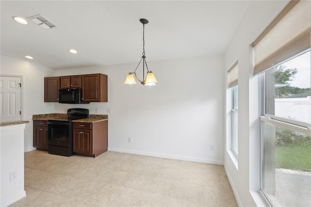 kitchen featuring black appliances, plenty of natural light, pendant lighting, and a chandelier