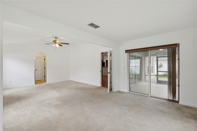 carpeted spare room with ceiling fan