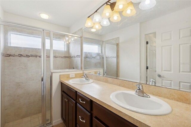 bathroom featuring vanity and an enclosed shower