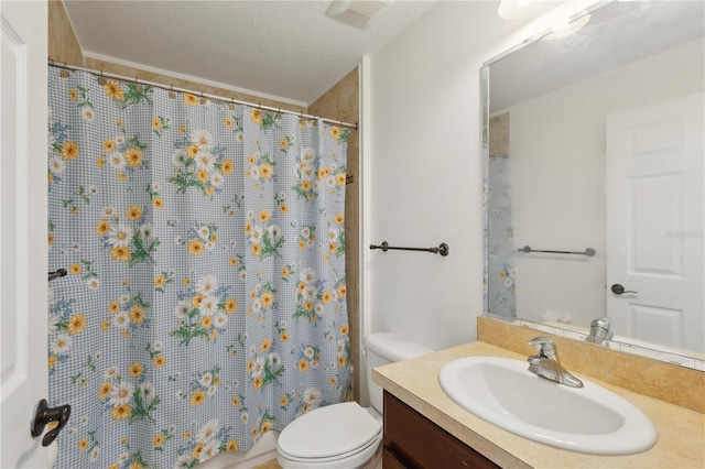 bathroom with vanity, a textured ceiling, and toilet