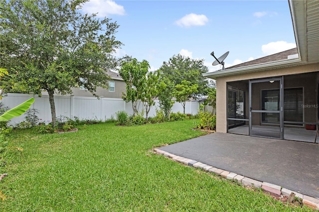 view of yard featuring a sunroom and a patio