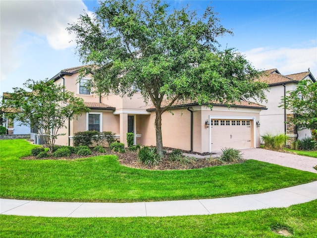 mediterranean / spanish-style house featuring stucco siding, a front yard, and a tiled roof