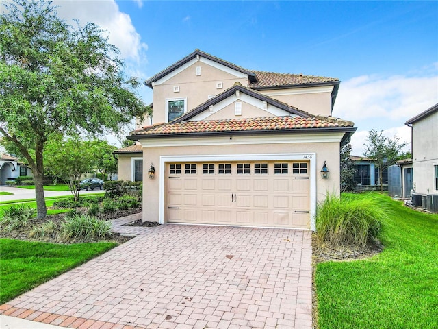 mediterranean / spanish-style house with a front lawn and central AC unit