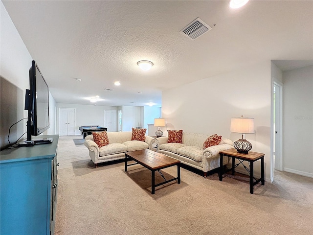 living area featuring light colored carpet, visible vents, billiards, and a textured ceiling