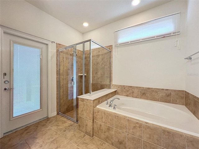 full bath featuring a stall shower, tile patterned flooring, recessed lighting, and a bath