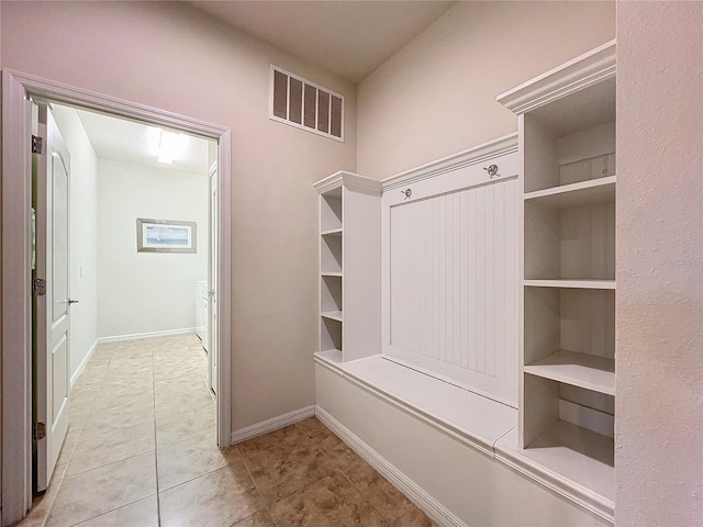 mudroom with visible vents, baseboards, and light tile patterned floors