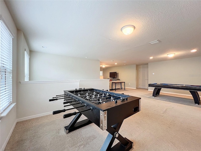 rec room with recessed lighting, visible vents, light carpet, a textured ceiling, and baseboards