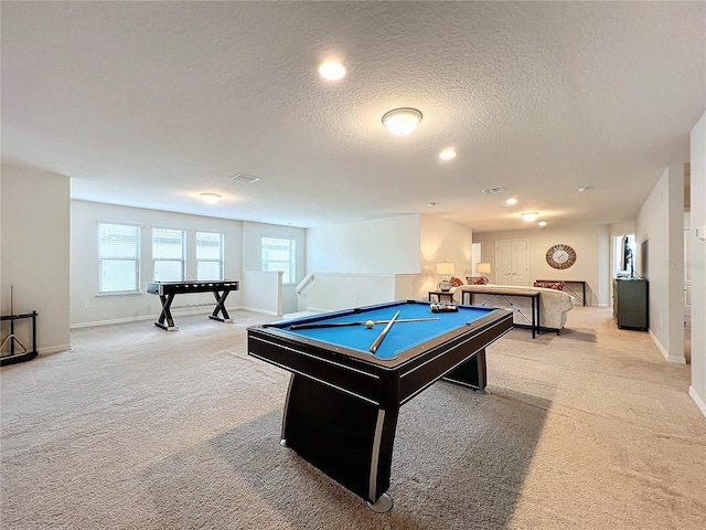 game room with pool table, light carpet, visible vents, and a textured ceiling