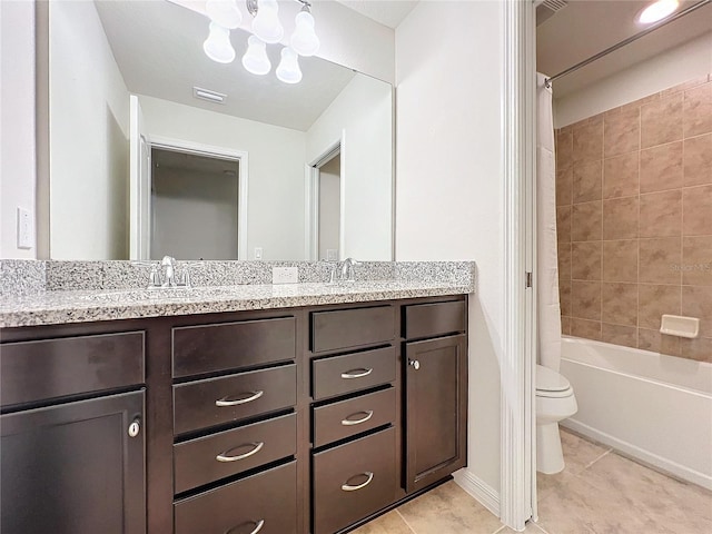 bathroom with double vanity, visible vents, toilet, a sink, and tile patterned flooring