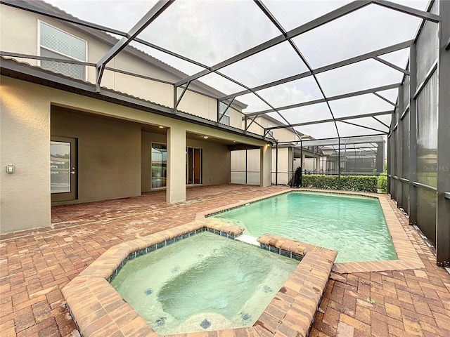 view of swimming pool with a patio area, a lanai, and a pool with connected hot tub