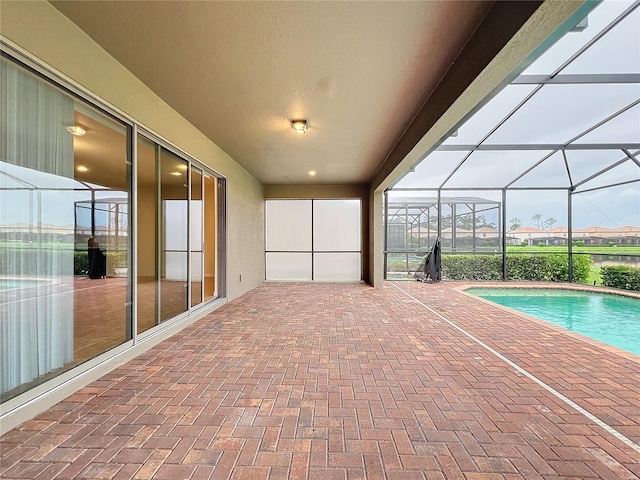 exterior space with glass enclosure and an outdoor pool