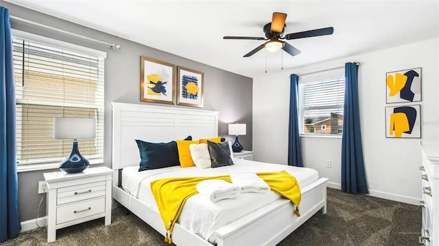 bedroom with ceiling fan, dark colored carpet, and baseboards