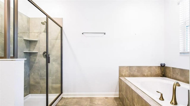 bathroom with tile patterned flooring and separate shower and tub