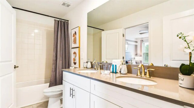 full bathroom featuring tile patterned flooring, shower / bath combination with curtain, toilet, and vanity